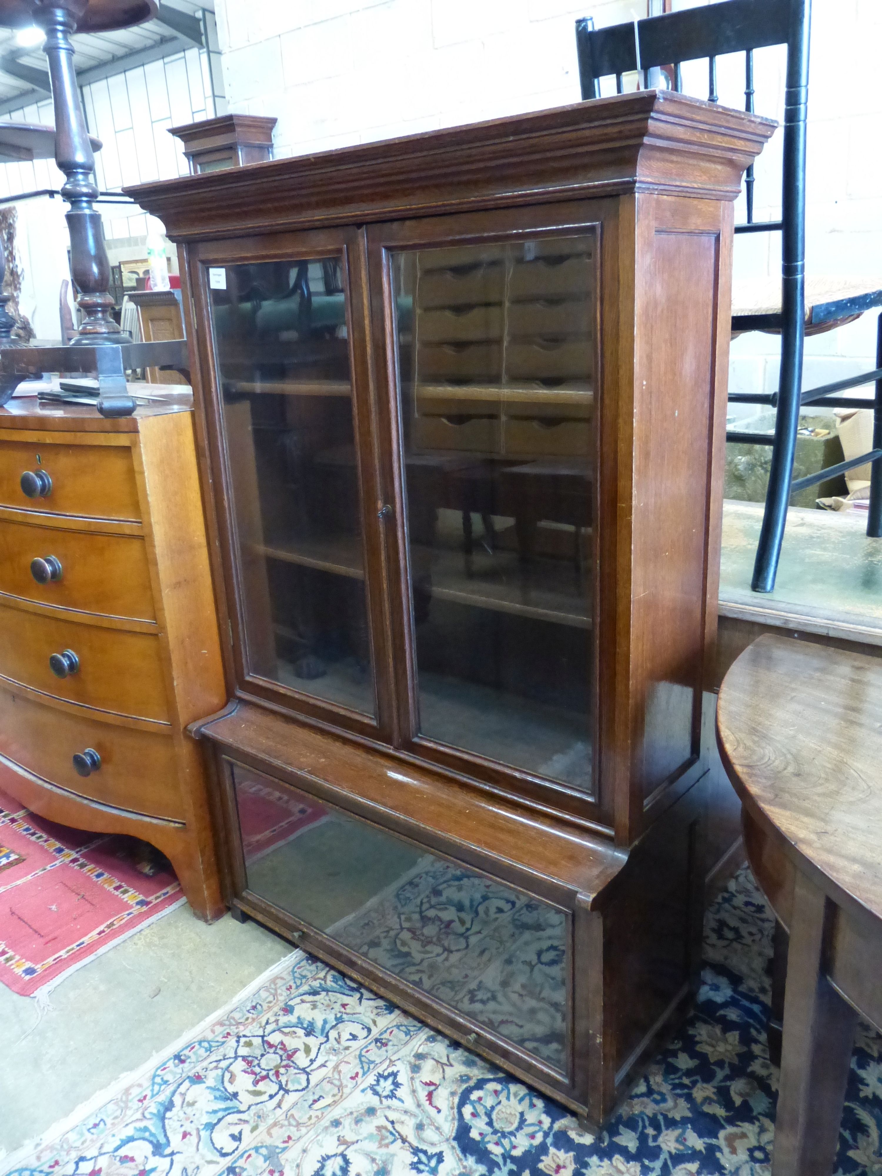 A 1920's standard oak bookcase, length 97cm, depth 37cm, height 138cm